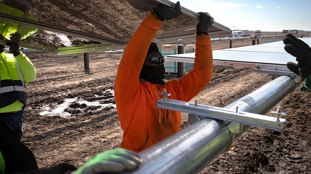 worker installing a solar panel